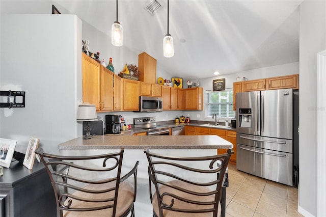 6362 N Walter Ter, Citrus Springs, FL 34434 - kitchen featuring appliances with stainless steel finishes, a peninsula, light tile patterned floors, decorative light fixtures, and a breakfast bar area