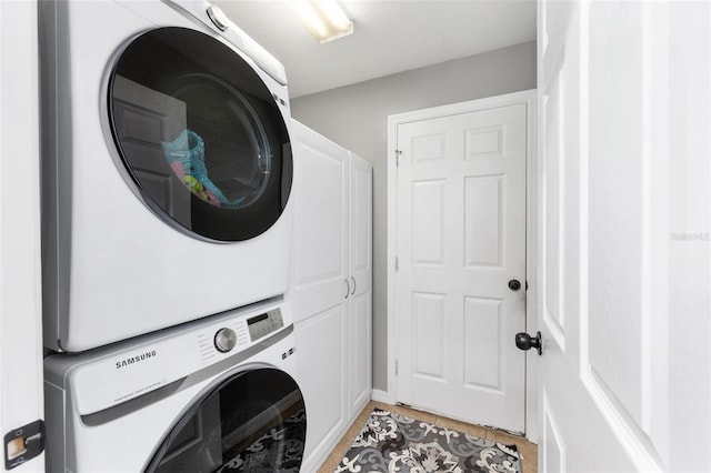 6362 N Walter Ter, Citrus Springs, FL 34434 - laundry area featuring stacked washer and clothes dryer, light tile patterned floors, and cabinet space