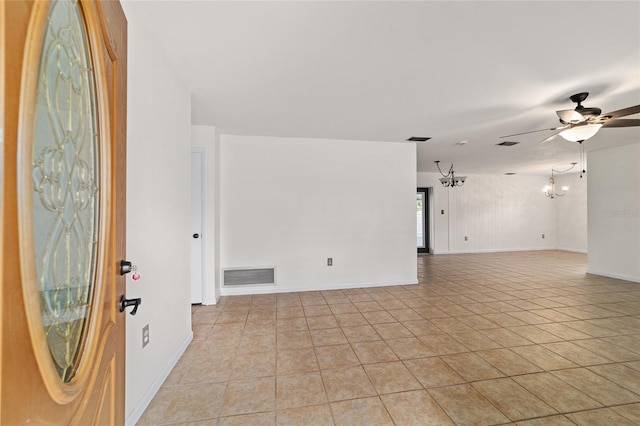 5500 SE 2nd Pl, Ocala, FL 34480 - empty room with a chandelier, a ceiling fan, and light tile patterned floors