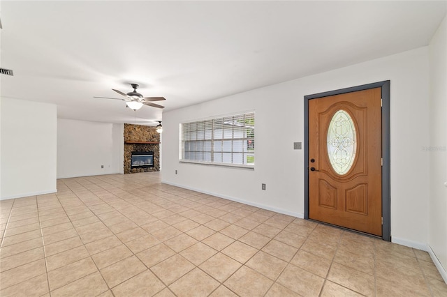 5500 SE 2nd Pl, Ocala, FL 34480 - foyer with a ceiling fan, a stone fireplace, and light tile patterned floors