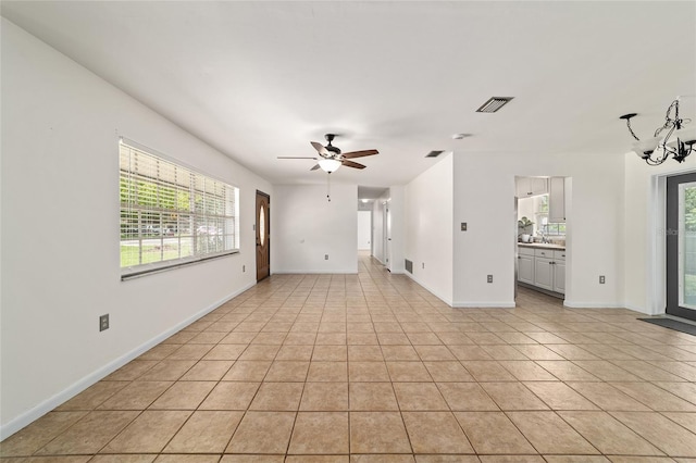 5500 SE 2nd Pl, Ocala, FL 34480 - unfurnished living room featuring light tile patterned floors, a ceiling fan, and a chandelier