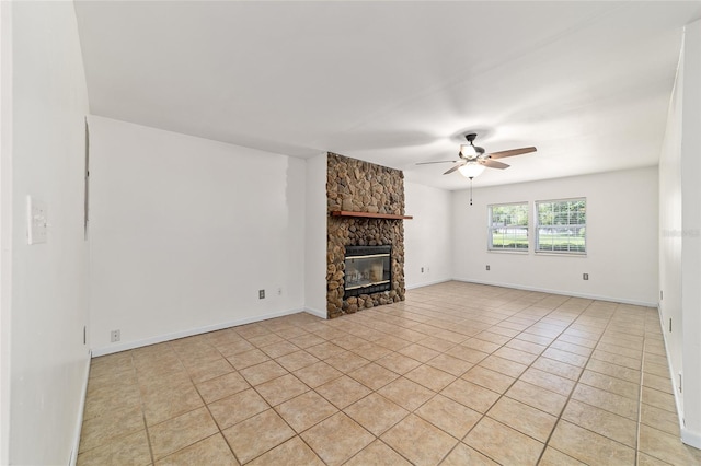 5500 SE 2nd Pl, Ocala, FL 34480 - unfurnished living room featuring a ceiling fan, light tile patterned floors, and a fireplace