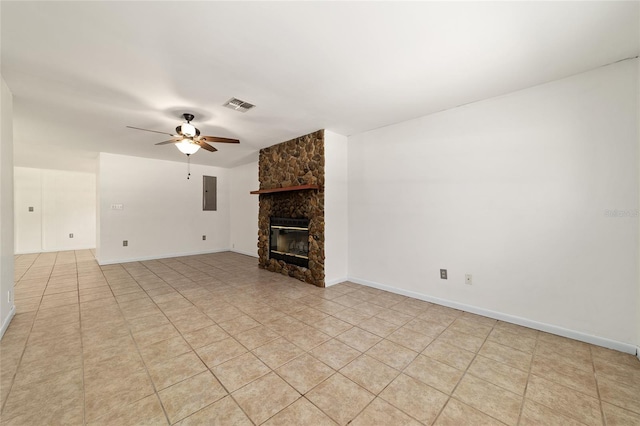 5500 SE 2nd Pl, Ocala, FL 34480 - unfurnished living room with electric panel, a ceiling fan, a fireplace, and light tile patterned floors