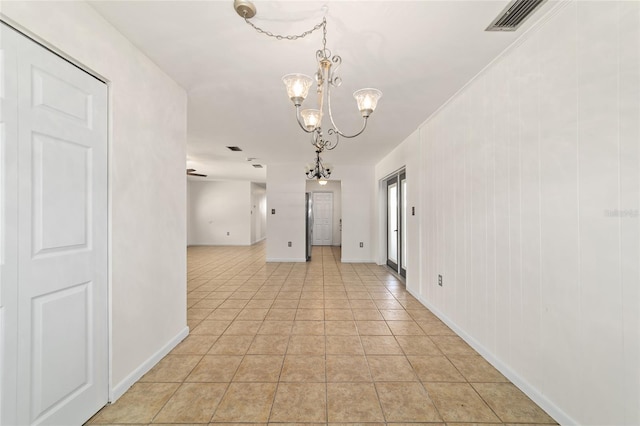 5500 SE 2nd Pl, Ocala, FL 34480 - empty room with a chandelier and light tile patterned flooring