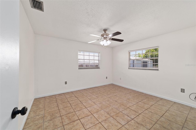5500 SE 2nd Pl, Ocala, FL 34480 - spare room with plenty of natural light, a textured ceiling, ceiling fan, and light tile patterned flooring