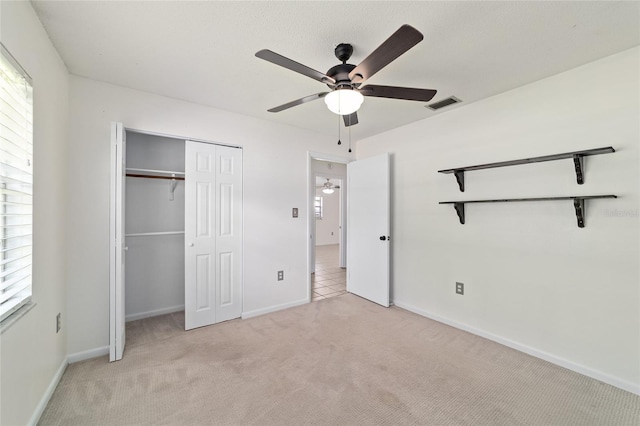 5500 SE 2nd Pl, Ocala, FL 34480 - unfurnished bedroom with light colored carpet, a closet, and a ceiling fan