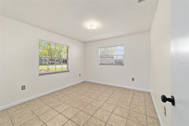 5500 SE 2nd Pl, Ocala, FL 34480 - spare room with plenty of natural light, a textured ceiling, and light tile patterned floors
