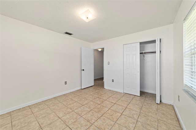 5500 SE 2nd Pl, Ocala, FL 34480 - unfurnished bedroom with a closet and light tile patterned floors