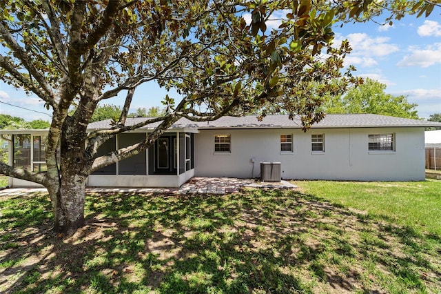 5500 SE 2nd Pl, Ocala, FL 34480 - back of house with a sunroom, a yard, and a shingled roof