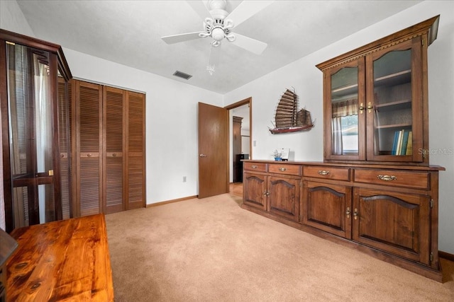 5525 NE 22nd Ave, Ocala, FL 34479 - bedroom with light carpet, a closet, and ceiling fan