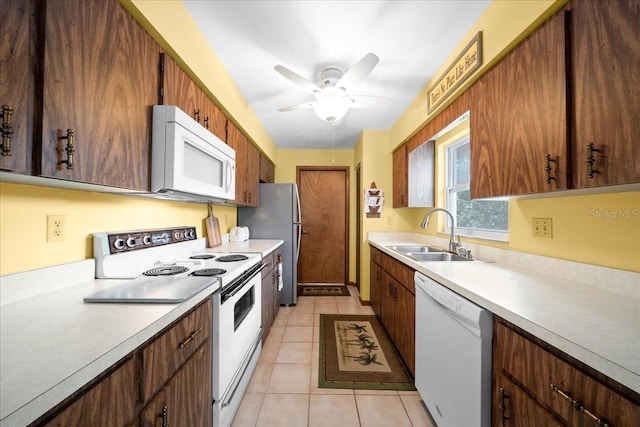 5525 NE 22nd Ave, Ocala, FL 34479 - kitchen with white appliances, light countertops, light tile patterned flooring, and ceiling fan