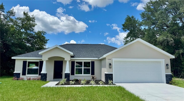 13305 SW 114th Pl, Dunnellon, FL 34432 - view of front of property featuring stucco siding, roof with shingles, a garage, driveway, and a front lawn