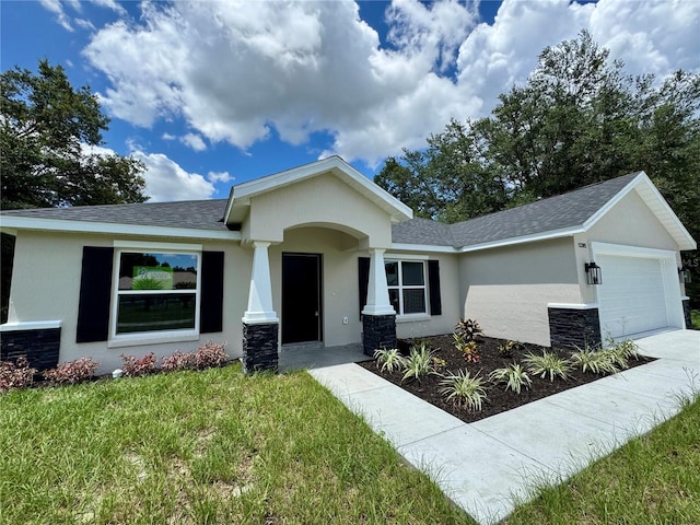 13305 SW 114th Pl, Dunnellon, FL 34432 - view of front of house featuring a garage, stucco siding, a front yard, and a shingled roof