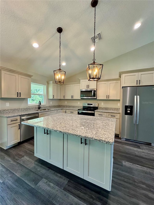 13305 SW 114th Pl, Dunnellon, FL 34432 - kitchen with stainless steel appliances, lofted ceiling, a center island, a textured ceiling, and dark wood-style floors