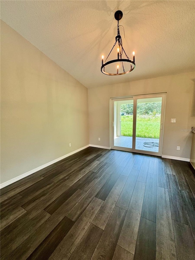 13305 SW 114th Pl, Dunnellon, FL 34432 - empty room featuring a chandelier, a textured ceiling, dark wood finished floors, and vaulted ceiling