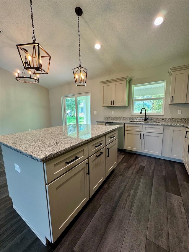 13305 SW 114th Pl, Dunnellon, FL 34432 - kitchen featuring stainless steel dishwasher, a textured ceiling, a center island, plenty of natural light, and a chandelier