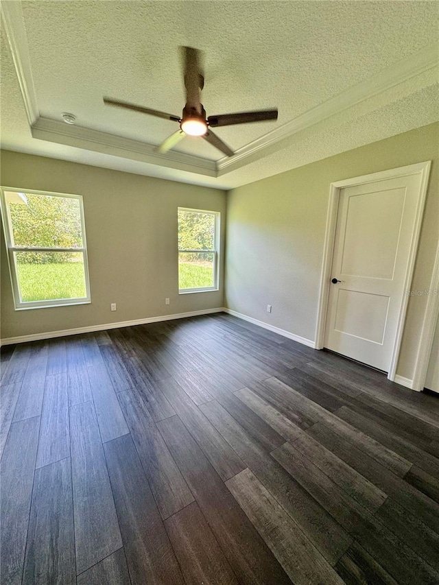 13305 SW 114th Pl, Dunnellon, FL 34432 - unfurnished room with a textured ceiling, a raised ceiling, ceiling fan, dark wood-type flooring, and crown molding