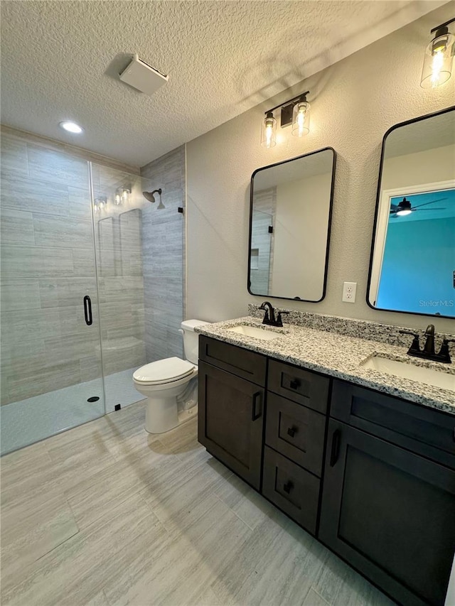 13305 SW 114th Pl, Dunnellon, FL 34432 - full bathroom with a textured ceiling, a shower stall, and double vanity