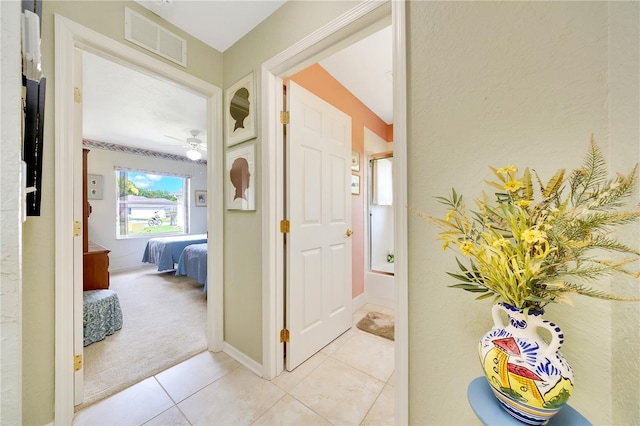 6330 SW 117th Loop, Ocala, FL 34476 - hallway with light tile patterned floors and light carpet