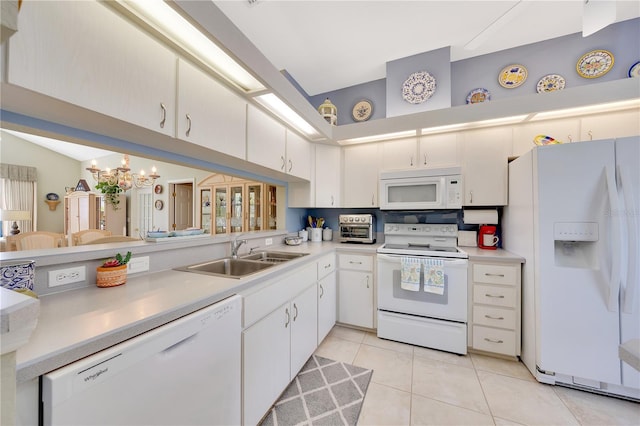 6330 SW 117th Loop, Ocala, FL 34476 - kitchen with white appliances, light countertops, light tile patterned flooring, white cabinets, and a high ceiling