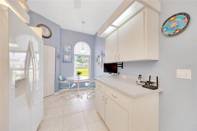 6330 SW 117th Loop, Ocala, FL 34476 - kitchen with white fridge with ice dispenser, white cabinets, light countertops, hanging light fixtures, and light tile patterned flooring