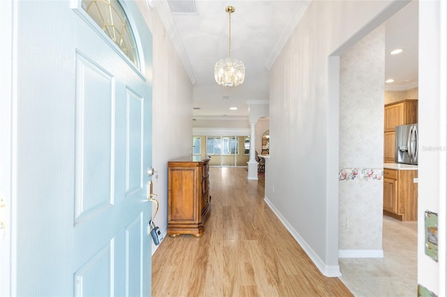 7243 SE 172nd Legacy Ln, The Villages, FL 32162 - entryway with a chandelier, ornamental molding, light wood finished floors, and recessed lighting
