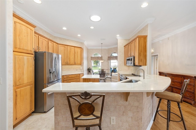 7243 SE 172nd Legacy Ln, The Villages, FL 32162 - kitchen with appliances with stainless steel finishes, a peninsula, light countertops, a kitchen bar, and recessed lighting