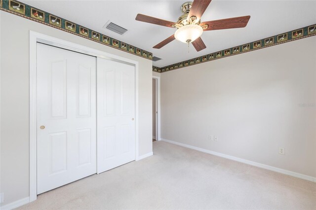7243 SE 172nd Legacy Ln, The Villages, FL 32162 - unfurnished bedroom with carpet, a closet, and a ceiling fan