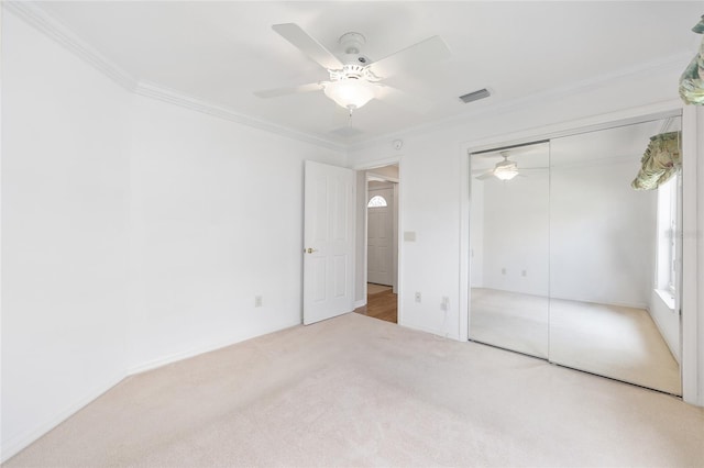 7243 SE 172nd Legacy Ln, The Villages, FL 32162 - unfurnished bedroom featuring carpet, crown molding, a closet, and a ceiling fan