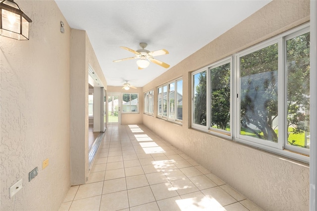7243 SE 172nd Legacy Ln, The Villages, FL 32162 - unfurnished sunroom featuring a textured wall and tile patterned floors