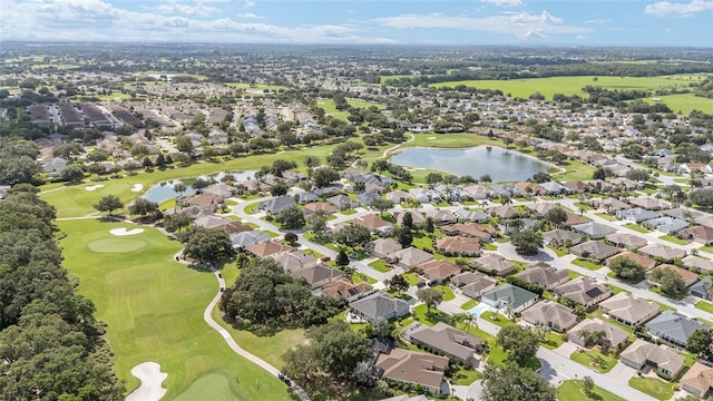 7243 SE 172nd Legacy Ln, The Villages, FL 32162 - aerial view of property and surrounding area featuring a golf course, a large body of water, and nearby suburban area
