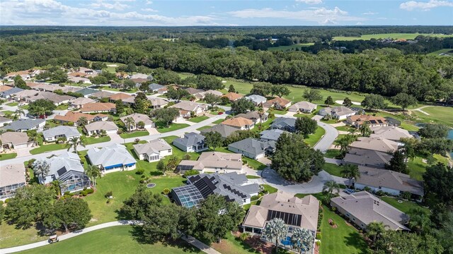7243 SE 172nd Legacy Ln, The Villages, FL 32162 - aerial overview of property's location with a heavily wooded area and nearby suburban area