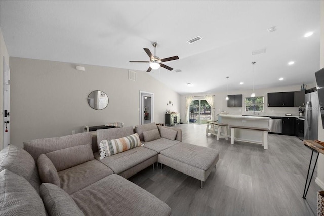 13479 SW 100th Ln, Dunnellon, FL 34432 - living room featuring light wood-style floors, ceiling fan, vaulted ceiling, and recessed lighting