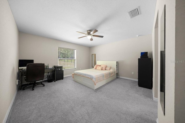 13479 SW 100th Ln, Dunnellon, FL 34432 - bedroom with carpet floors, a desk, a ceiling fan, and a textured ceiling