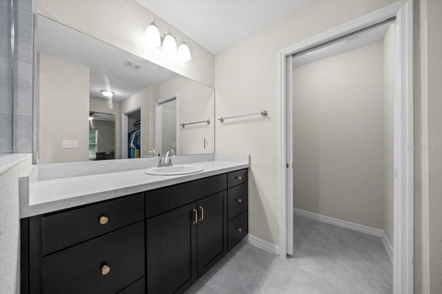 13479 SW 100th Ln, Dunnellon, FL 34432 - bathroom with vanity, a walk in closet, and tile patterned floors