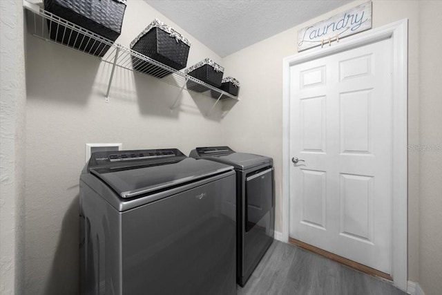13479 SW 100th Ln, Dunnellon, FL 34432 - laundry room featuring washer and dryer, wood finished floors, and a textured ceiling