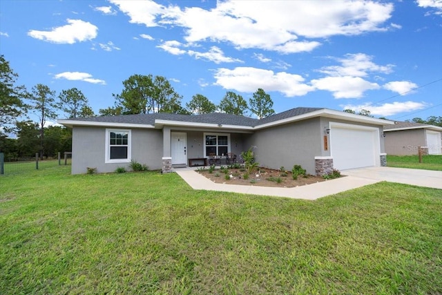 13479 SW 100th Ln, Dunnellon, FL 34432 - view of front of home with stucco siding, a garage, covered porch, driveway, and a front yard