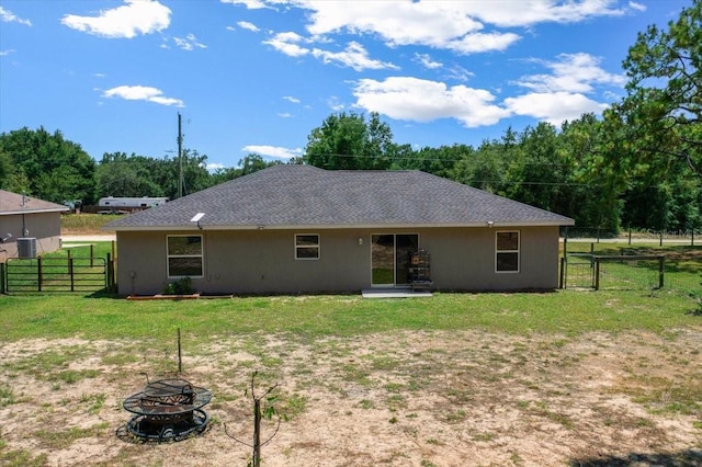 13479 SW 100th Ln, Dunnellon, FL 34432 - rear view of property featuring a gate, an outdoor fire pit, and stucco siding