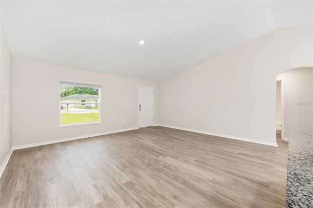5 Water Pass, Ocala, FL 34472 - empty room with lofted ceiling, arched walkways, and light wood-style floors