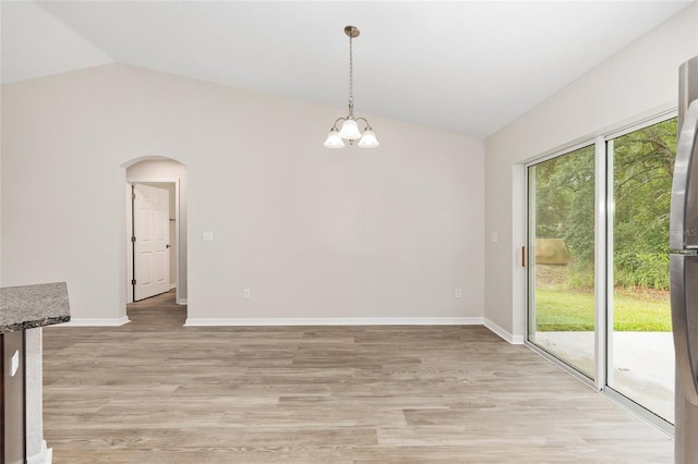 5 Water Pass, Ocala, FL 34472 - unfurnished dining area with vaulted ceiling, arched walkways, light wood-style flooring, and a chandelier
