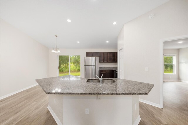 5 Water Pass, Ocala, FL 34472 - kitchen featuring freestanding refrigerator, dark brown cabinetry, light wood-style floors, healthy amount of natural light, and recessed lighting