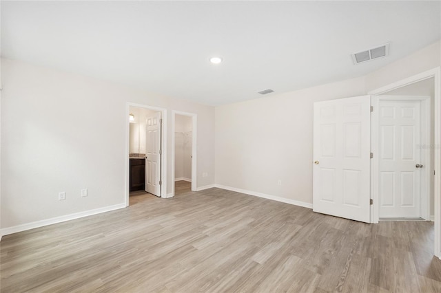 5 Water Pass, Ocala, FL 34472 - unfurnished bedroom with light wood-type flooring, recessed lighting, and a walk in closet