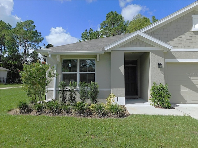 80 Hickory Course Loop, Ocala, FL 34472 - view of front of house with stucco siding, a front yard, and an attached garage