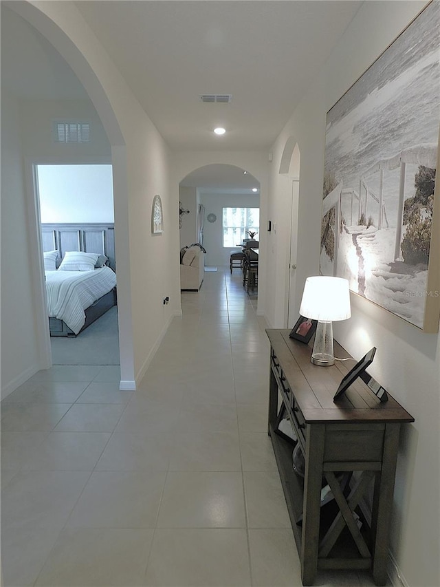 80 Hickory Course Loop, Ocala, FL 34472 - corridor featuring arched walkways, light tile patterned flooring, and recessed lighting