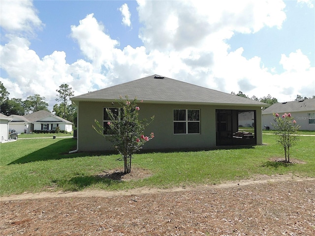 80 Hickory Course Loop, Ocala, FL 34472 - rear view of house featuring stucco siding, a lawn, and a sunroom