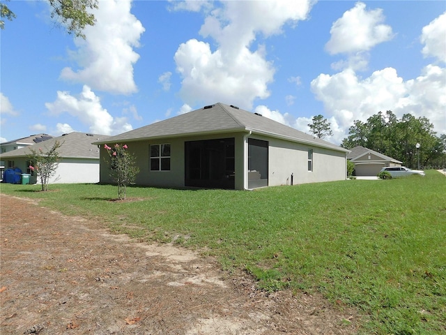 80 Hickory Course Loop, Ocala, FL 34472 - back of house with a yard, stucco siding, and a sunroom
