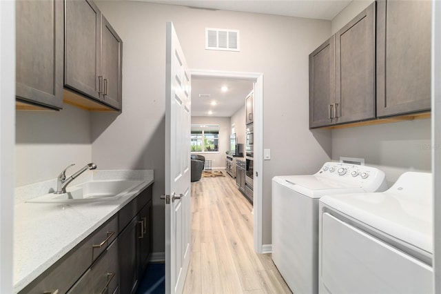 8913 SW 76th Ln, Ocala, FL 34481 - laundry area featuring cabinet space, light wood-style floors, washing machine and clothes dryer, and recessed lighting