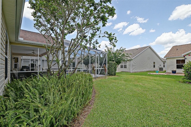 3146 Williams Rd, The Villages, FL 32162 - view of grassy yard featuring a ceiling fan and glass enclosure