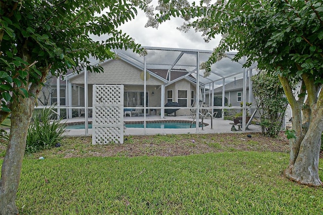 3146 Williams Rd, The Villages, FL 32162 - back of house with glass enclosure, a yard, a patio area, and an outdoor pool