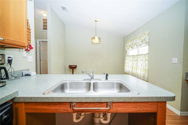 5347 Pecan Rd, Ocala, FL 34472 - kitchen featuring light countertops, light wood-style flooring, decorative light fixtures, lofted ceiling, and brown cabinets